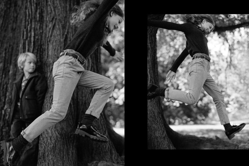 Young girl climbing a tree in stylish Massimo Dutti kids clothing.