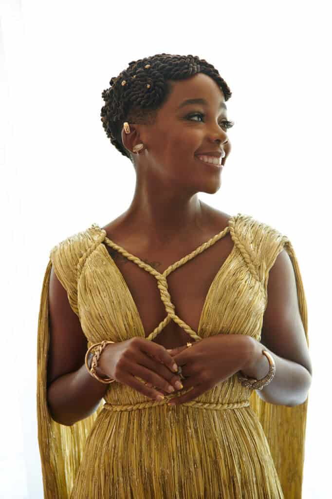 Elegant woman in gold dress at Critic's Choice Awards, Dior event.