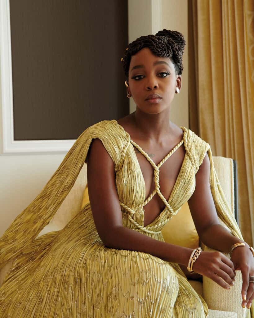 Elegant woman in gold dress at Critic's Choice Awards event.