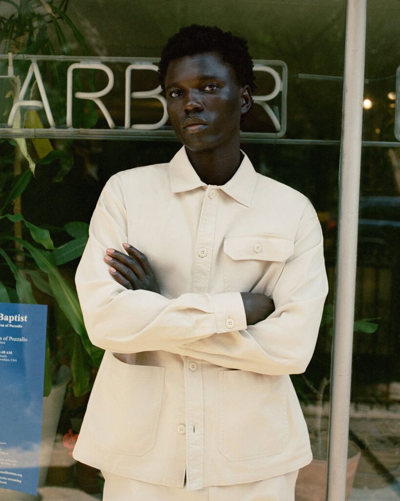 Stylish young man in Zara Man beige jacket at Brooklyn location, 2022.
