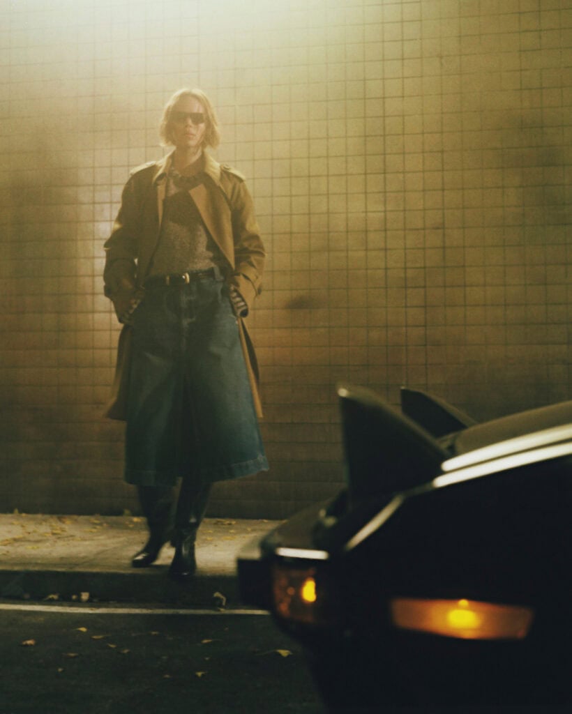 Fashion model wearing KHAITE Freja 2022 outfit in urban setting.