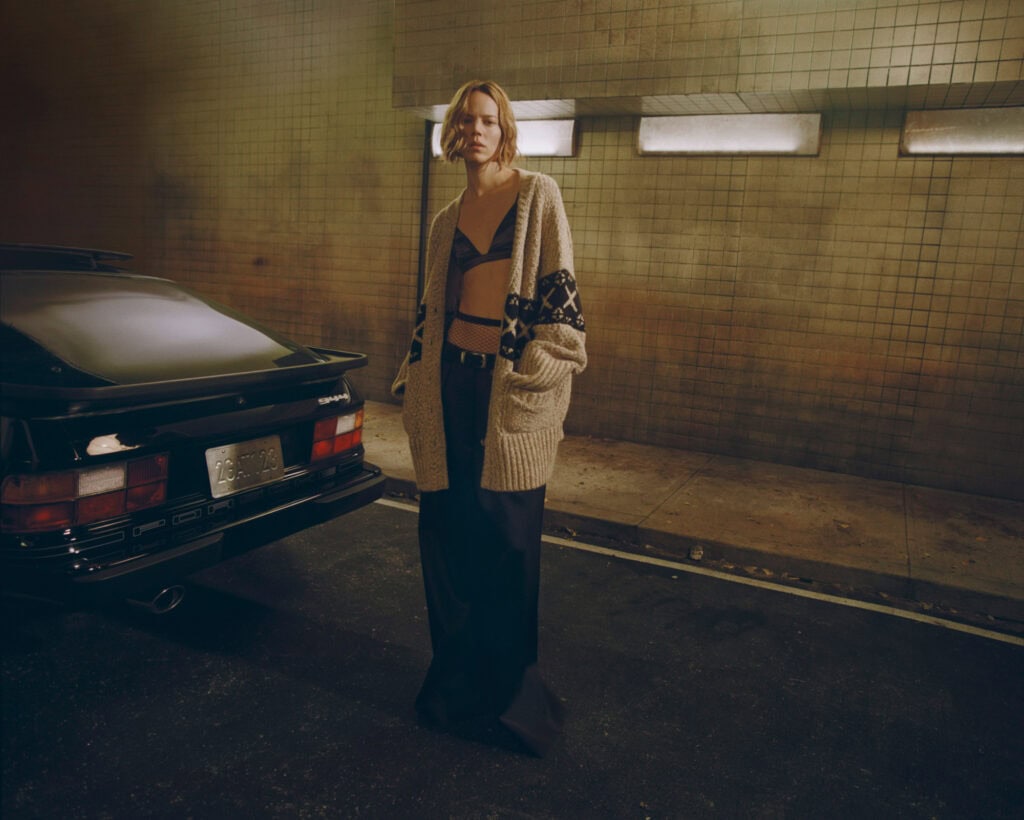 Freja model wearing KHAITE outfit in urban parking garage.