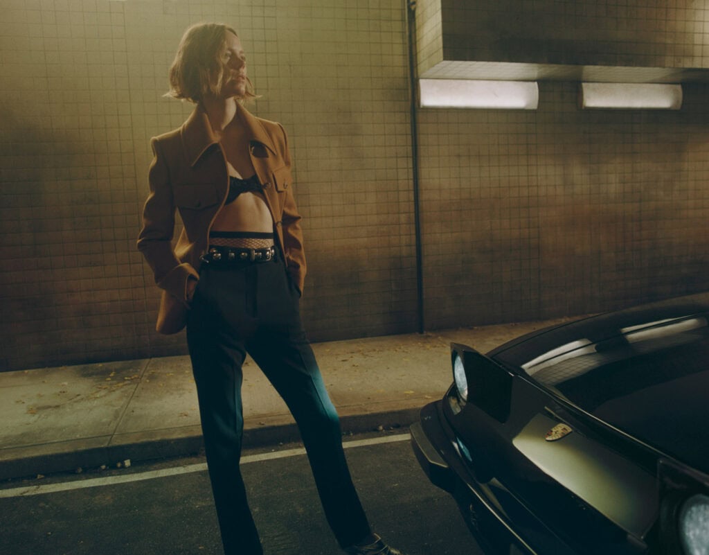 Stylish woman in urban setting wearing KHAITE Freja 2022 outfit.