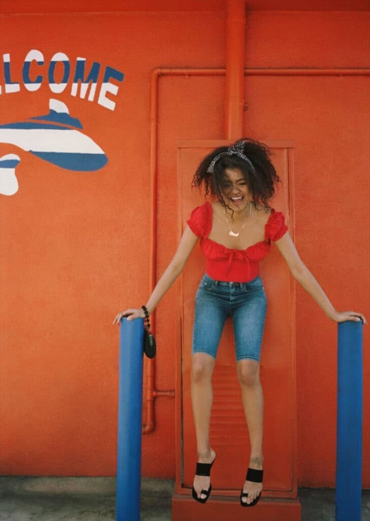 Woman smiling at Urban Outfitters store in Los Angeles, 2019.