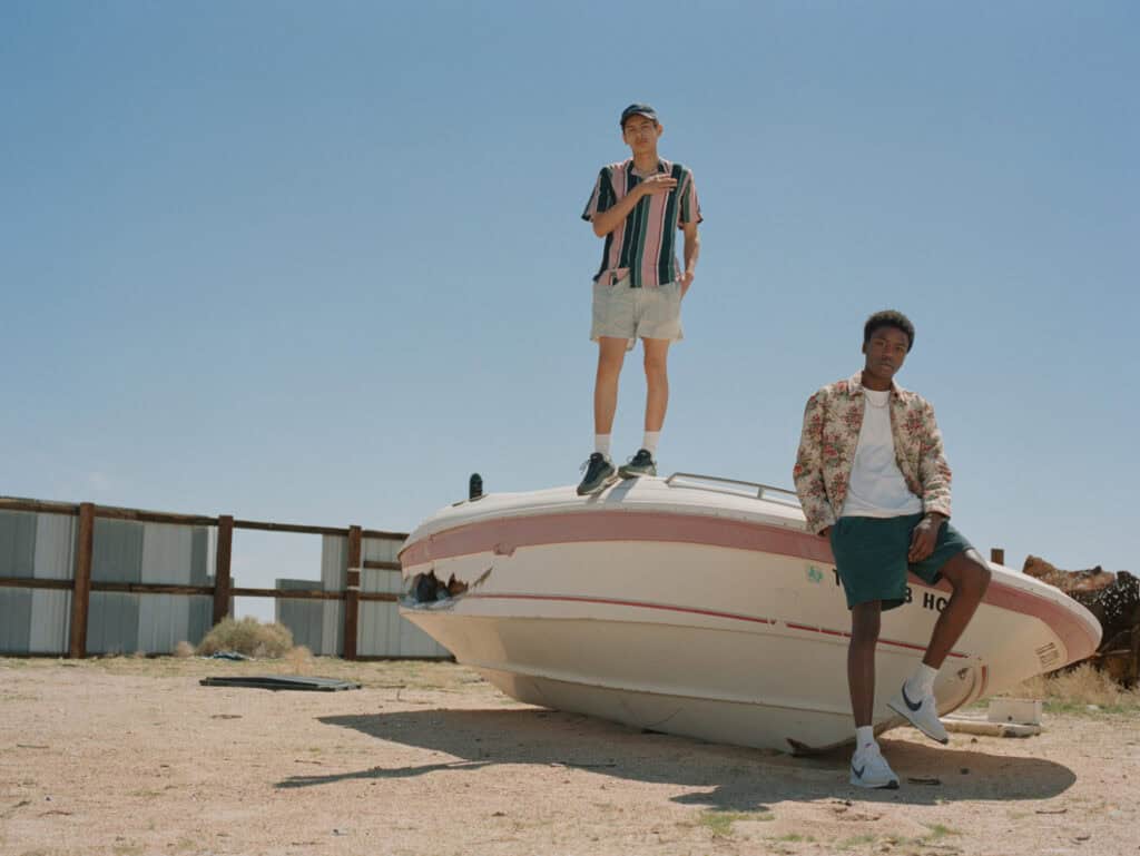Urban Outfits in a desert setting with a boat and models.