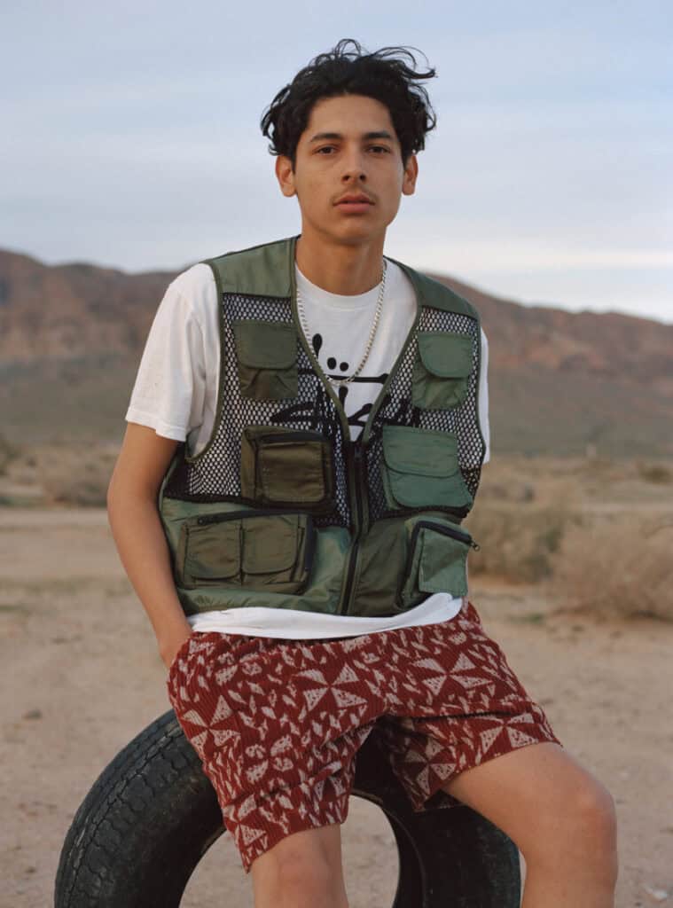 Urban Outfitter model wearing outdoor gear in desert setting.