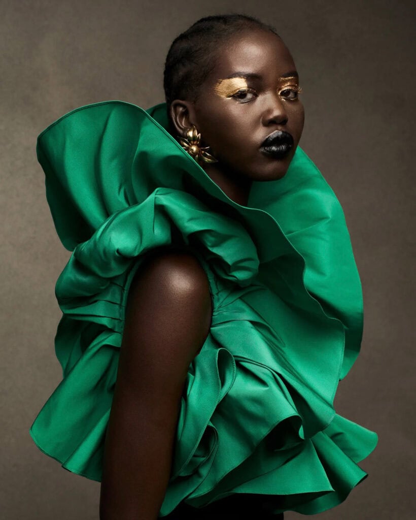 Elegant model in bold green fashion for US Vogue Proportions.