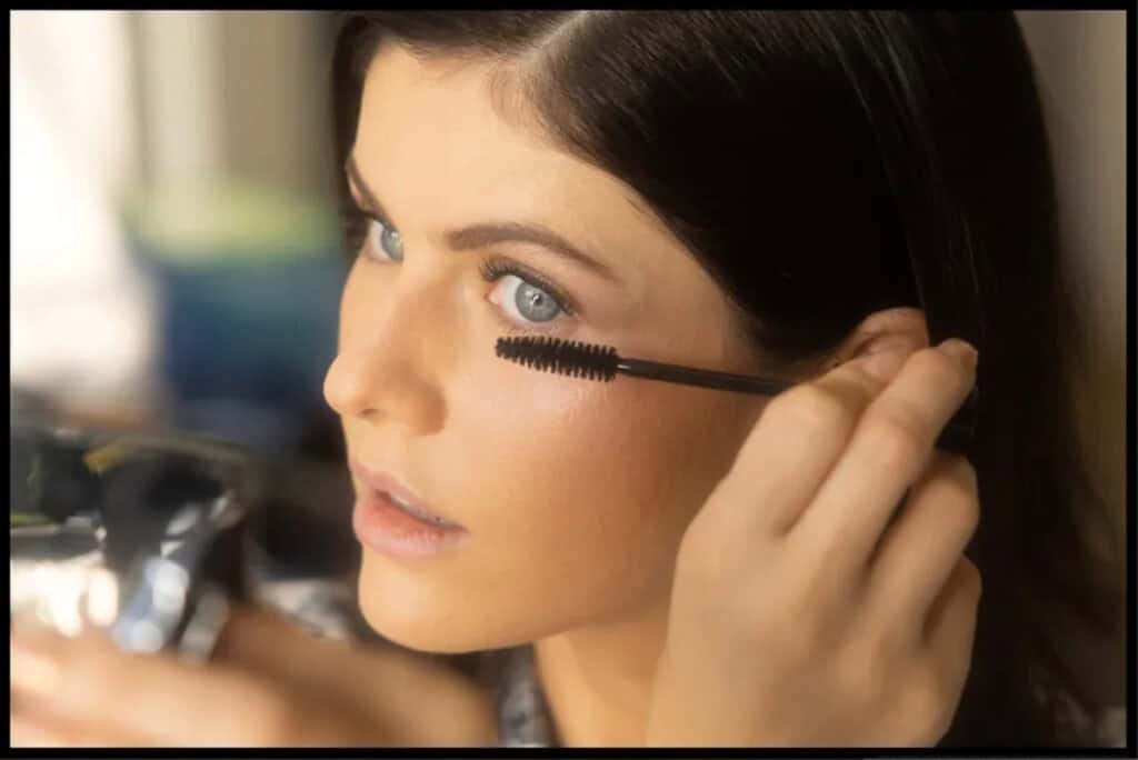 Alexandra Daddario applying mascara at Dior Emmy Awards event.
