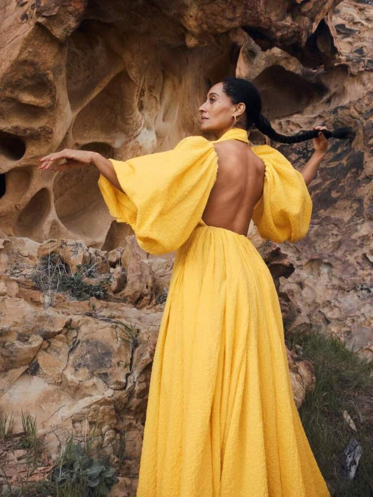 Elegant Tracee Ellis Ross in a yellow gown outdoors.