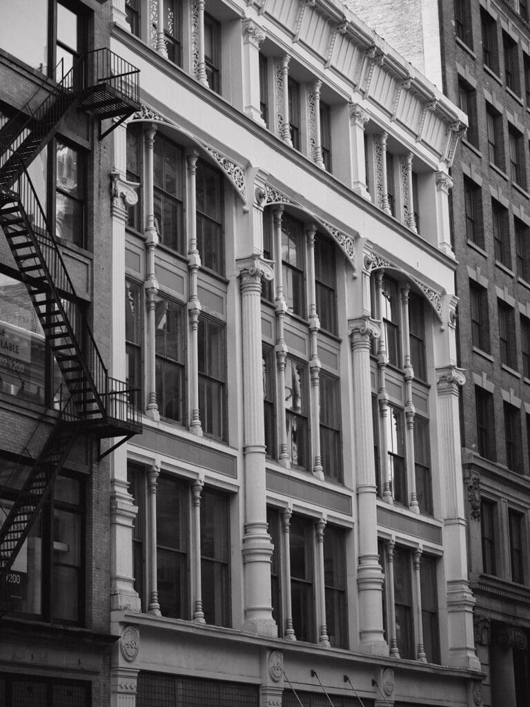 Historic NYC building facade with ornate architectural details in black and white.