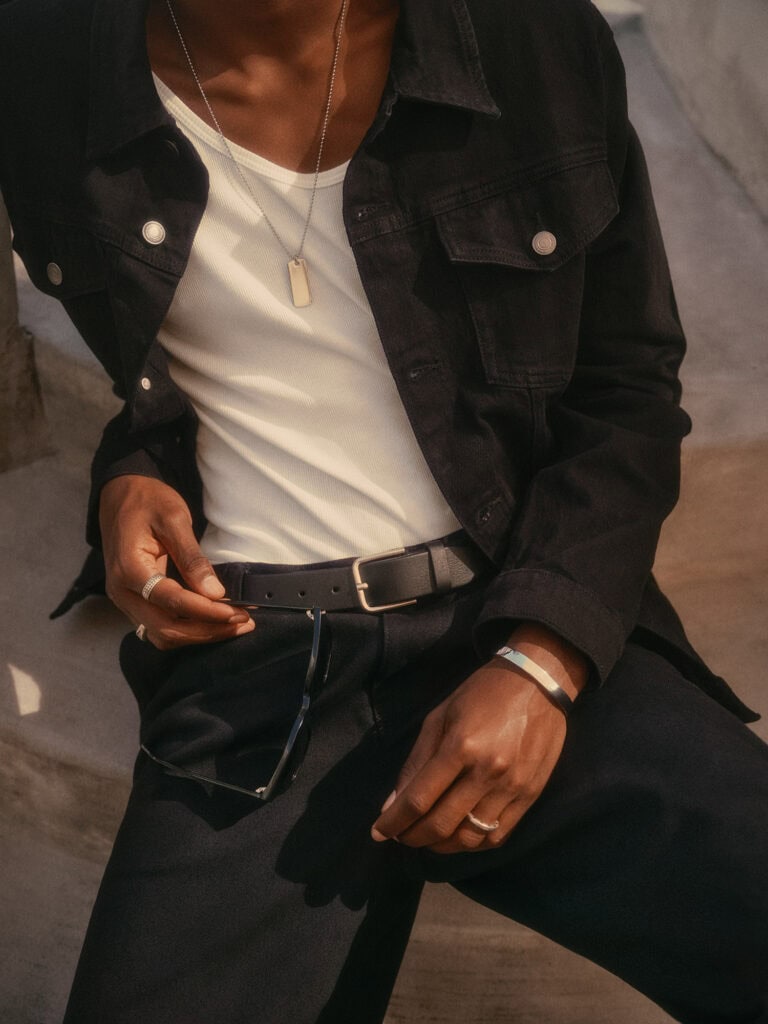 Men's fashion in Los Angeles, 2022, featuring stylish black denim and accessories.