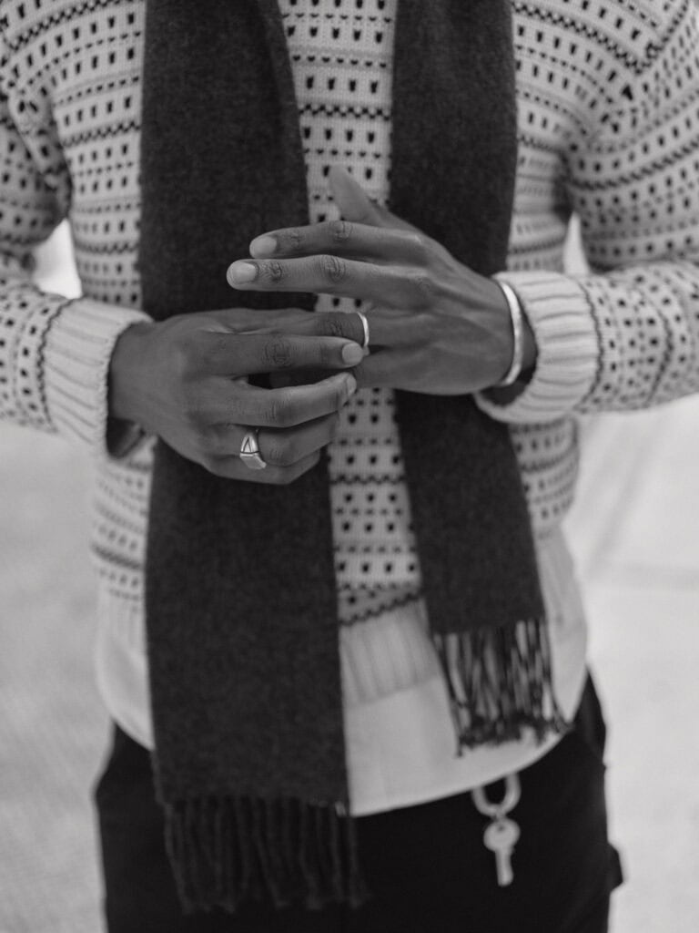 Close-up of stylish men's accessories with rings and watch in NYC, 2023.