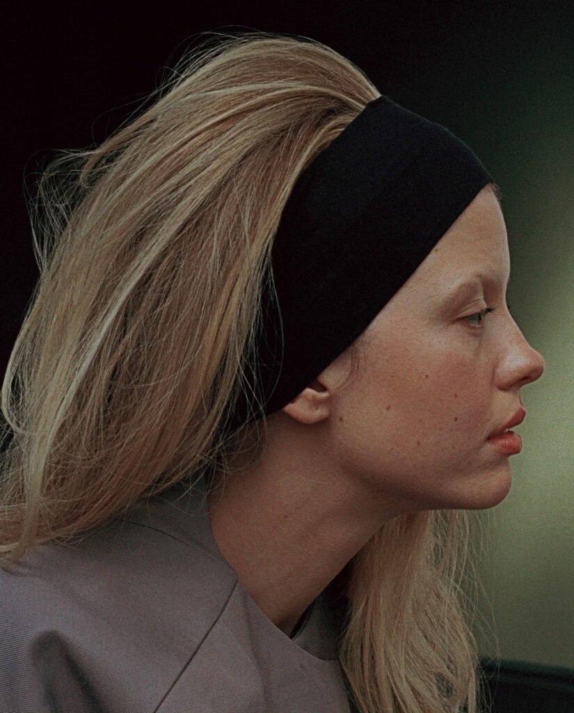 Mia Goth in a profile shot for Cultured Magazine, showcasing her natural beauty and fashion style.