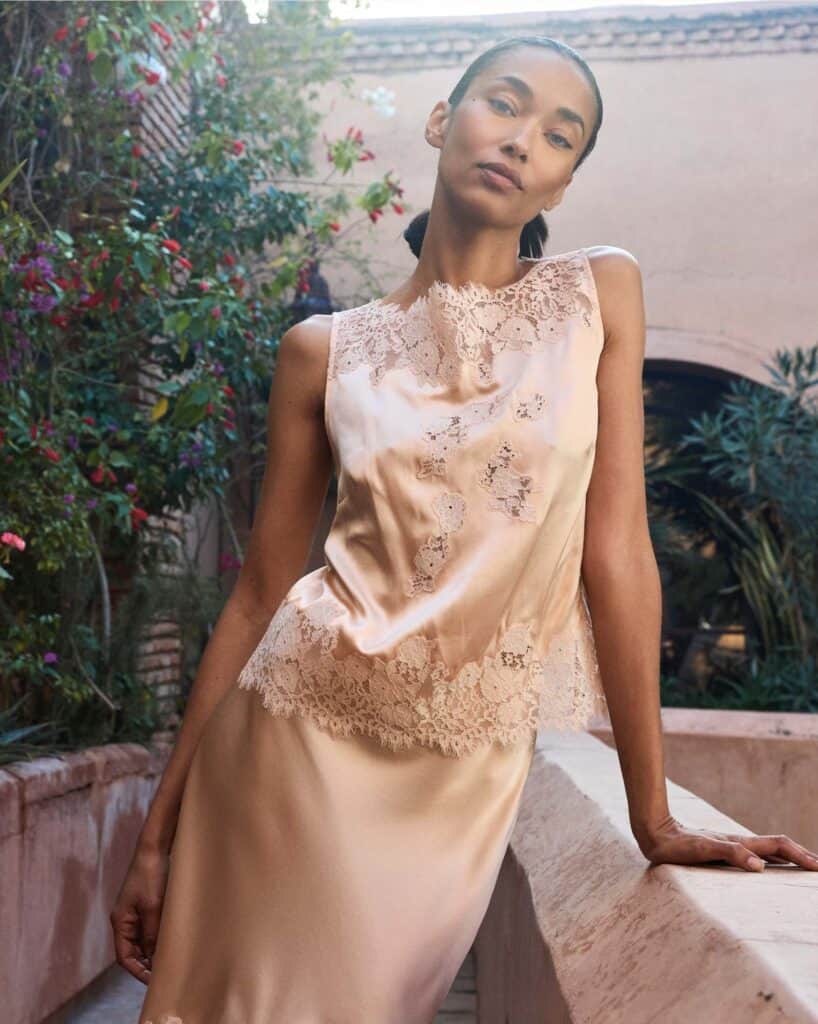Elegant woman in lace dress outdoors in Morocco.