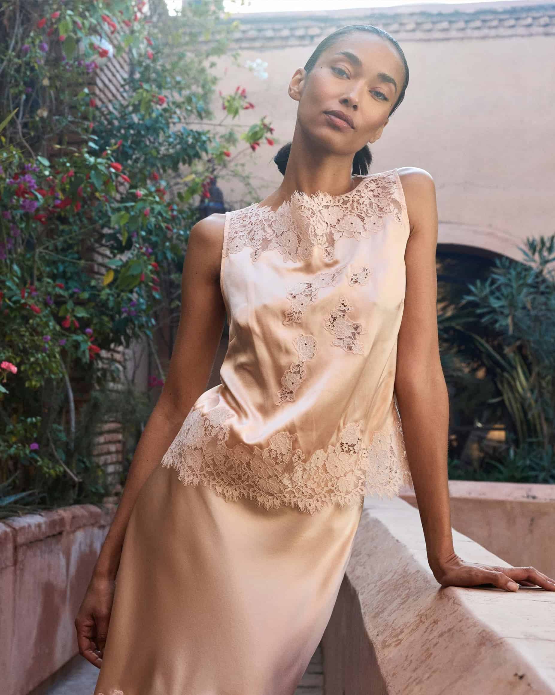 Elegant woman in lace dress outdoors in Morocco.