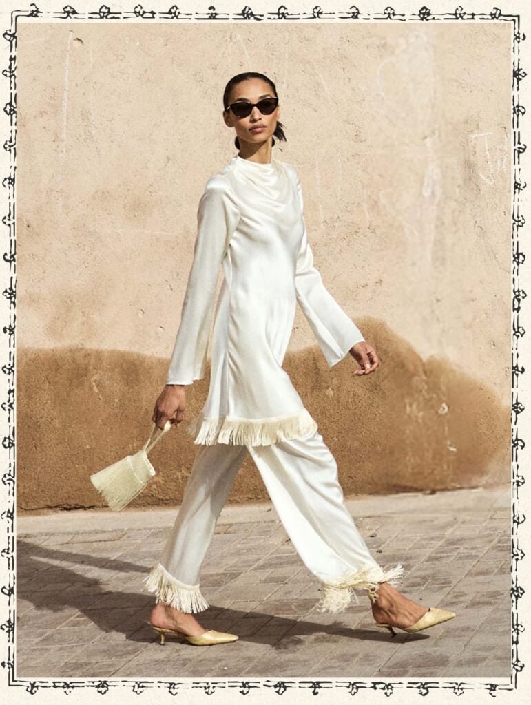 Elegant white fashion outfit with fringed details, perfect for Moroccan style and cultural events.