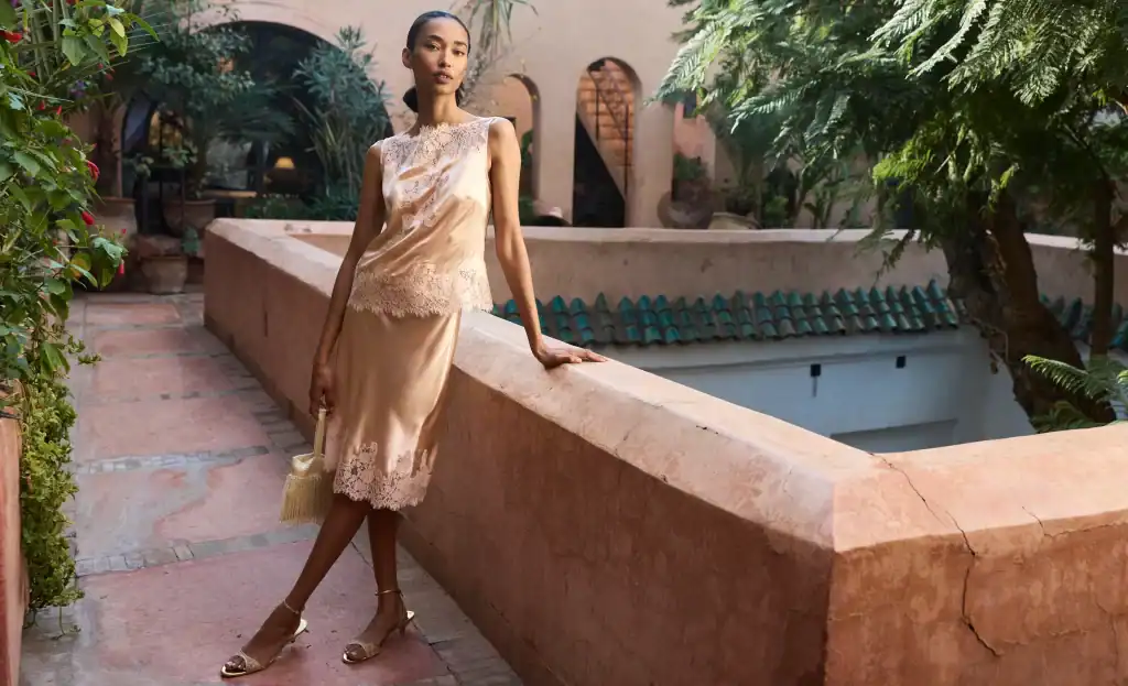 Elegant model in traditional Moroccan-inspired dress outdoors in Morocco.